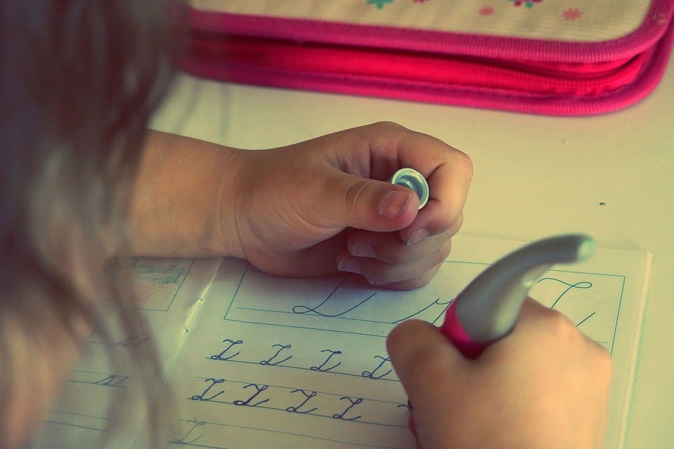 A little girl practicing her writing skills