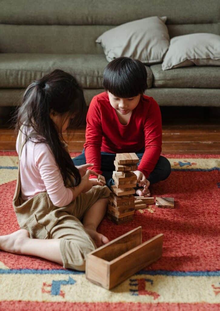 Kids playing jenga together