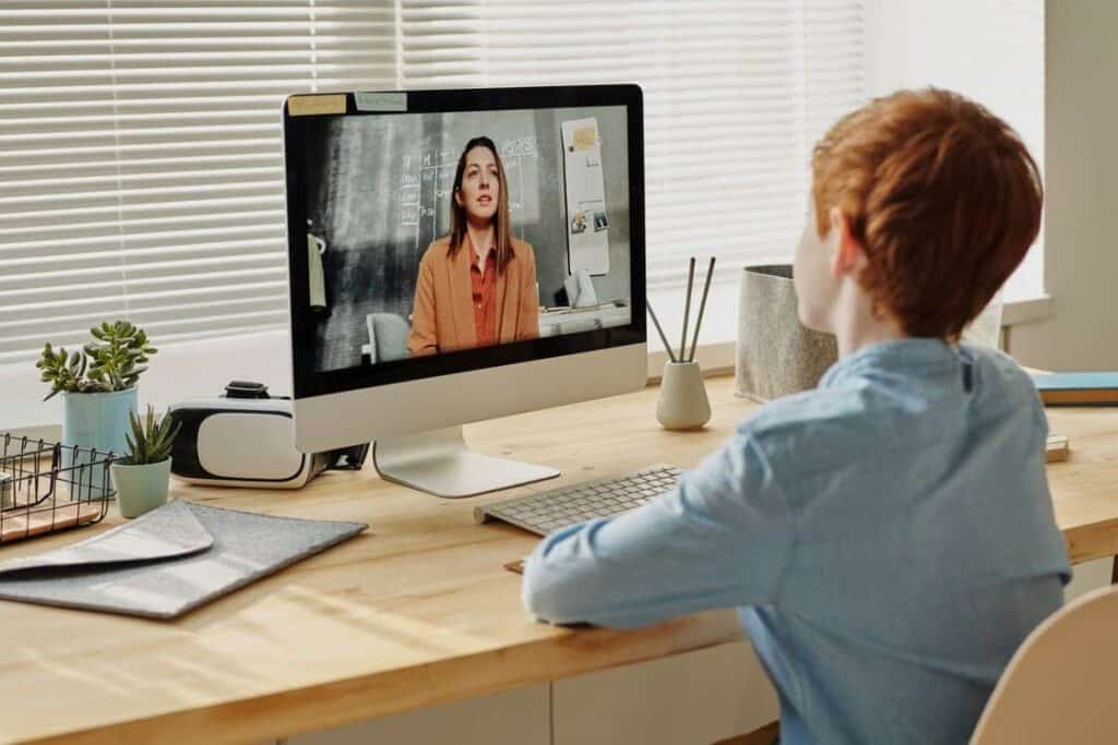 a boy taking an online language class from home