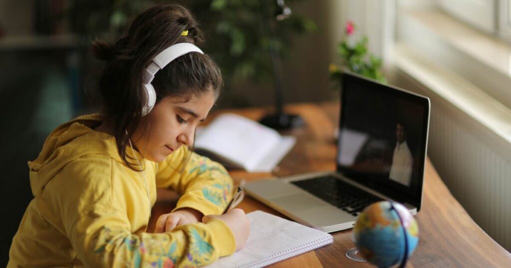 girl attending an online class at home