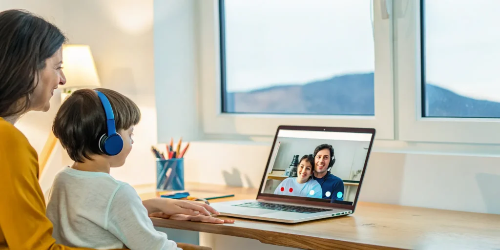 Parent helping a child with their online dual language immersion school in Utah.