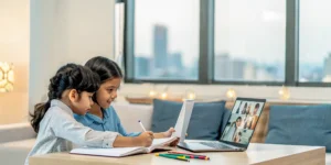 Two children studying online for their English and Spanish homeschool program for expats.