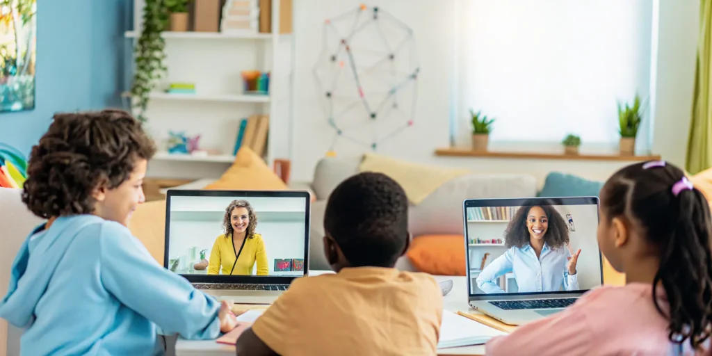 Homeschool students learning online in a virtual bilingual classroom with a teacher on screen