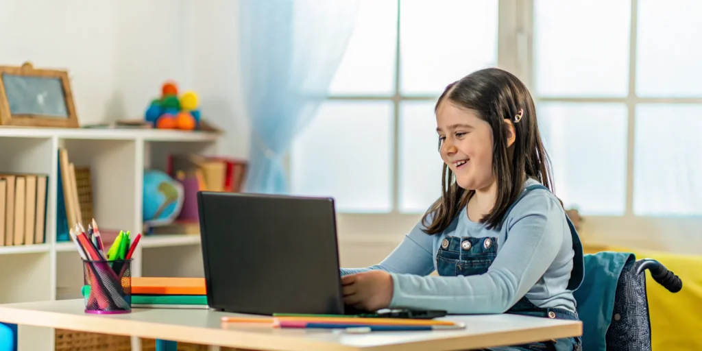 Student learning online from home with laptop and notebooks on desk